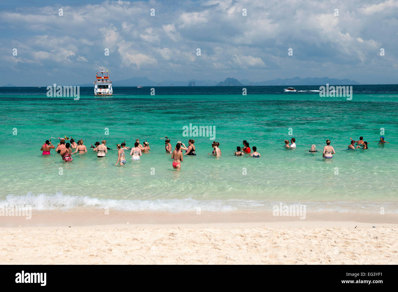 Swimmers & snorkellers in the waters of Bamboo island (Ko Mai Phai) near Koh Phi Phi in the Andaman Sea on Thailand's west coast Stock Photo