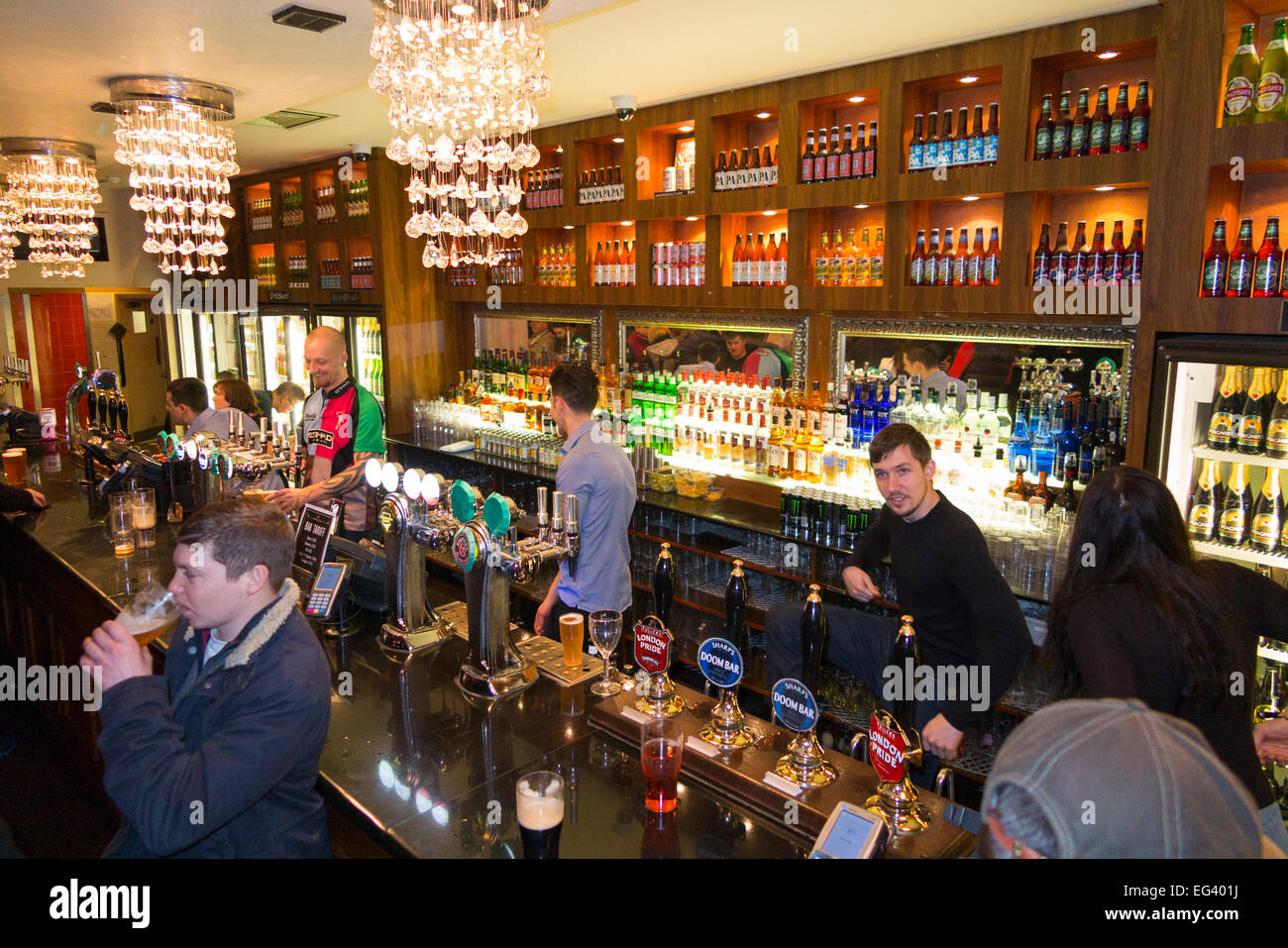 Rugby fan at bar inside The William b Ellis pub / public house
