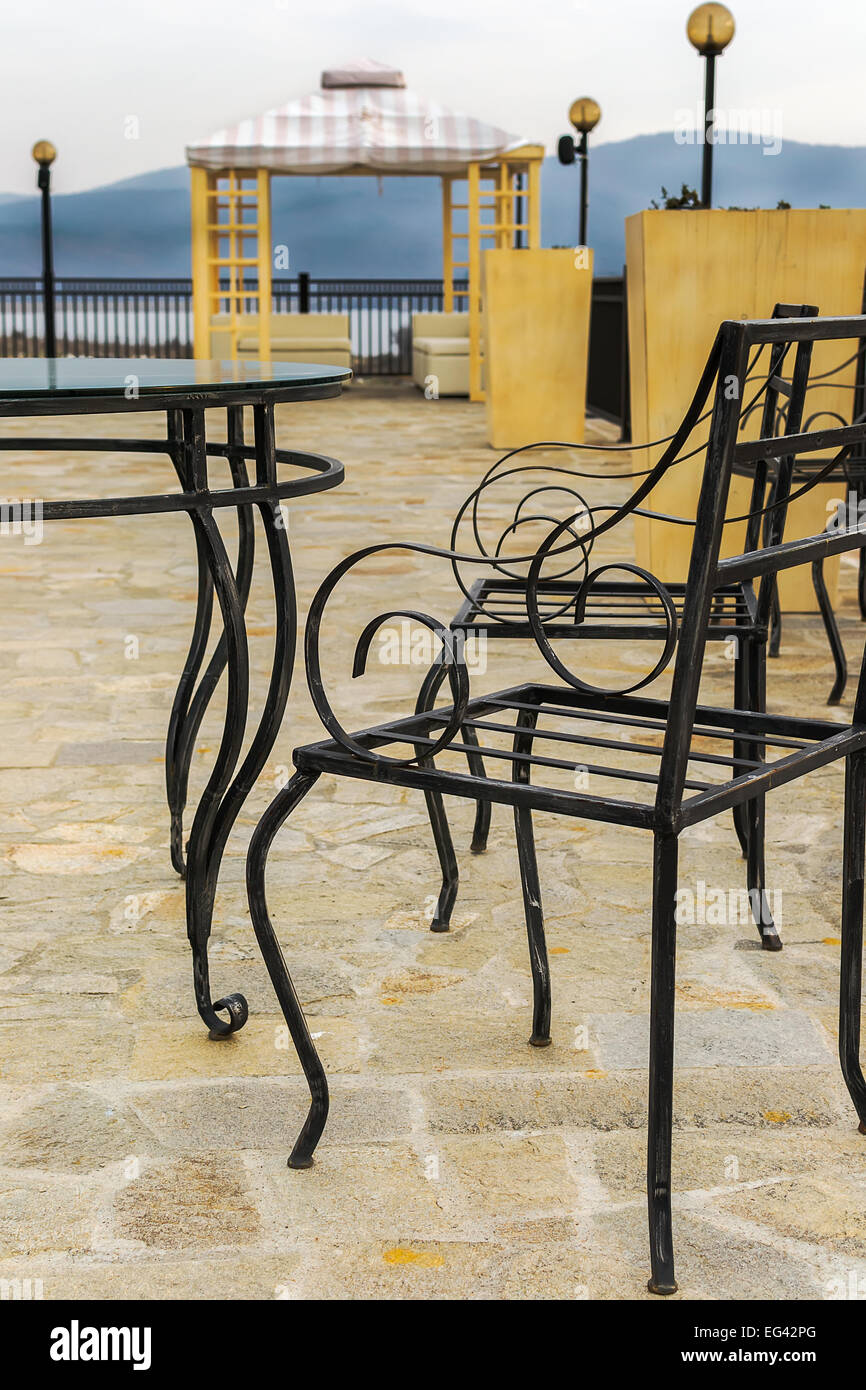 Wrought iron table and chairs near the pool Stock Photo