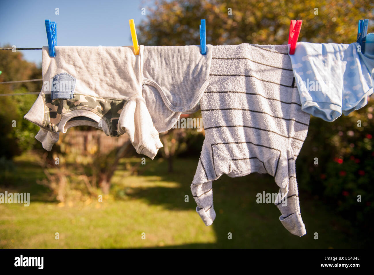 Childrens clothes hanging on a line to dry Stock Photo