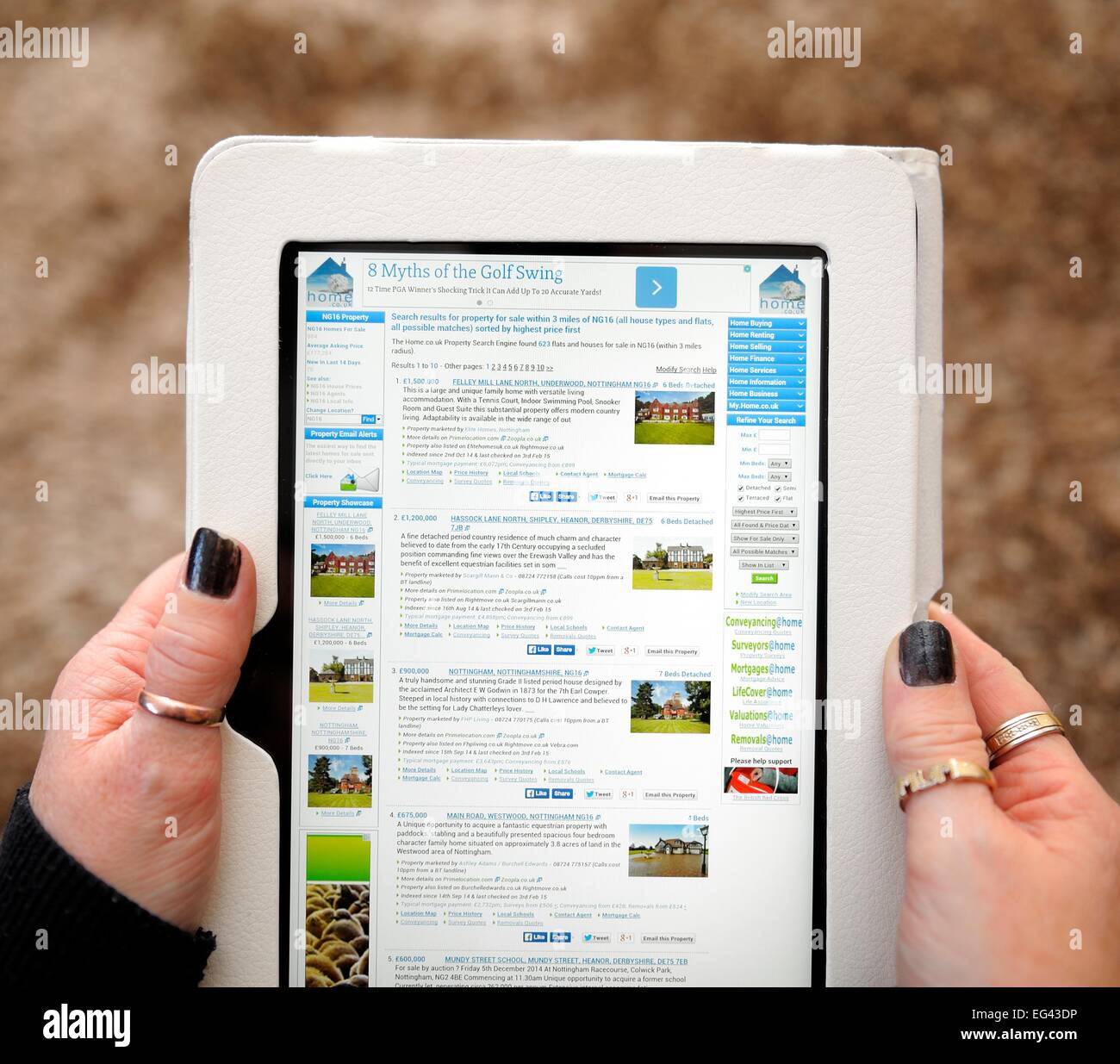 A kindle fire being used to view houses for sale England UK Stock Photo