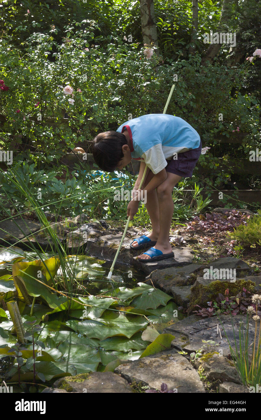 young primary secondary school boy enjoying themselves pond fishing
