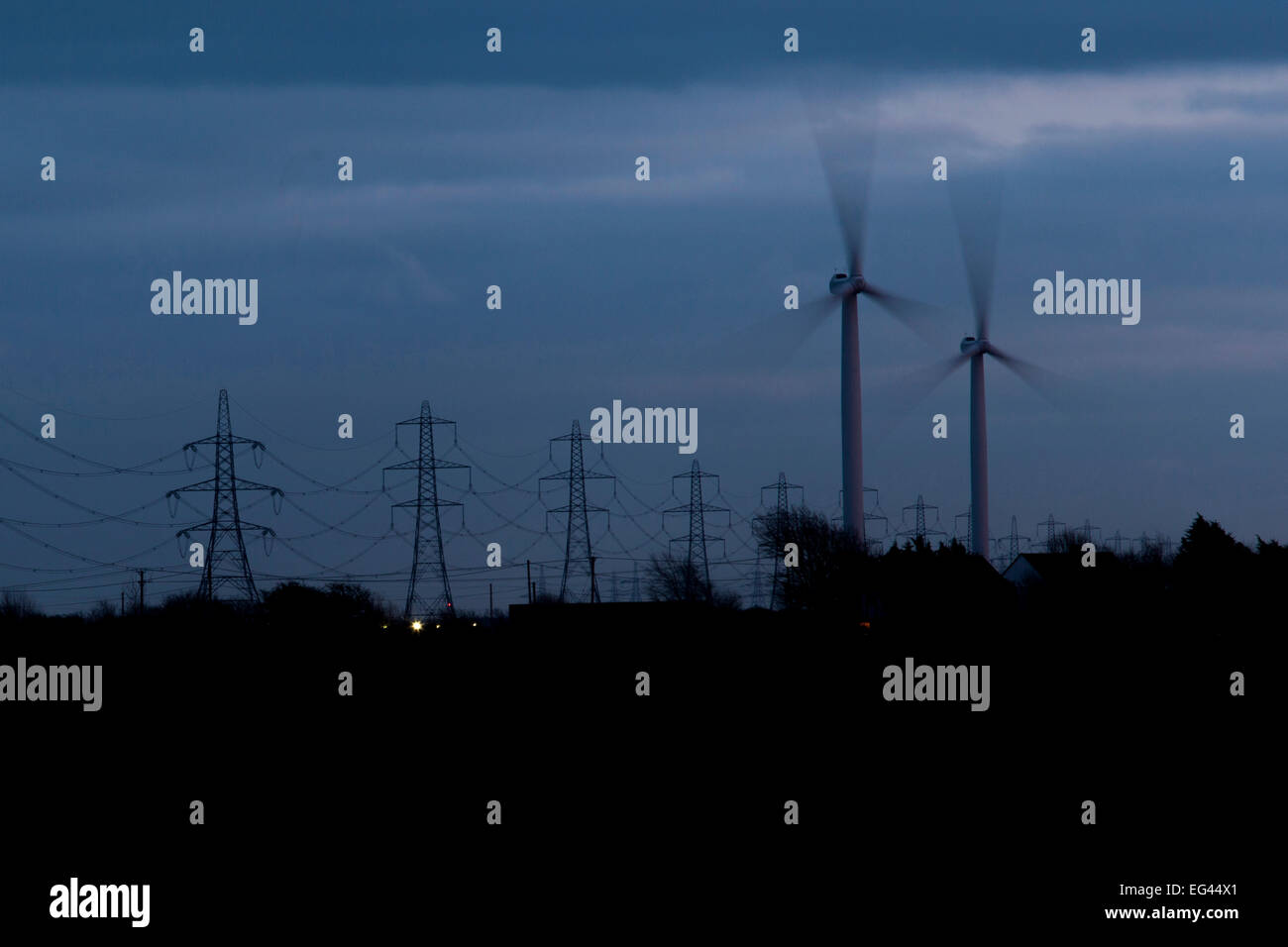 Windturbines and electricity pylons at night on Romney Marsh, Kent, UK. Stock Photo