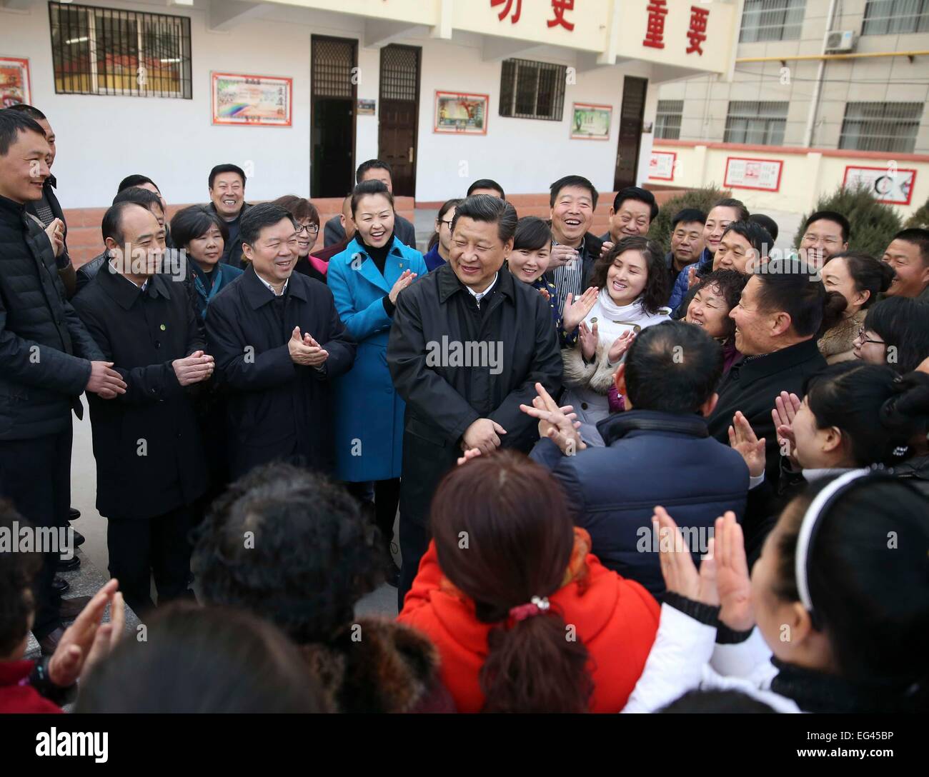 Xi'an, China's Shaanxi Province. 14th Feb, 2015. Chinese President and General Secretary of the Communist Party of China Central Committee Xi Jinping (C), also chairman of the Central Military Commission, chats with local residents after inspecting a primary school in Yan'an, northwest China's Shaanxi Province, Feb. 14, 2015. Xi made a tour in Shaanxi on Feb. 13 - 16, and extended festival greetings to locals and people across the nation ahead of the Spring Festival, which falls on Feb. 19. © Lan Hongguang/Xinhua/Alamy Live News Stock Photo