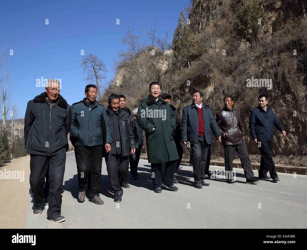 Xi'an, China's Shaanxi Province. 13th Feb, 2015. Chinese President and General Secretary of the Communist Party of China Central Committee Xi Jinping (C), also chairman of the Central Military Commission, visits people in Liangjiahe Village, Wen'anyi Township of Yanchuan County, Yan'an, northwest China's Shaanxi Province, Feb. 13, 2015. Xi made a tour in Shaanxi on Feb. 13 - 16, and extended festival greetings to locals and people across the nation ahead of the Spring Festival, which falls on Feb. 19. © Lan Hongguang/Xinhua/Alamy Live News Stock Photo