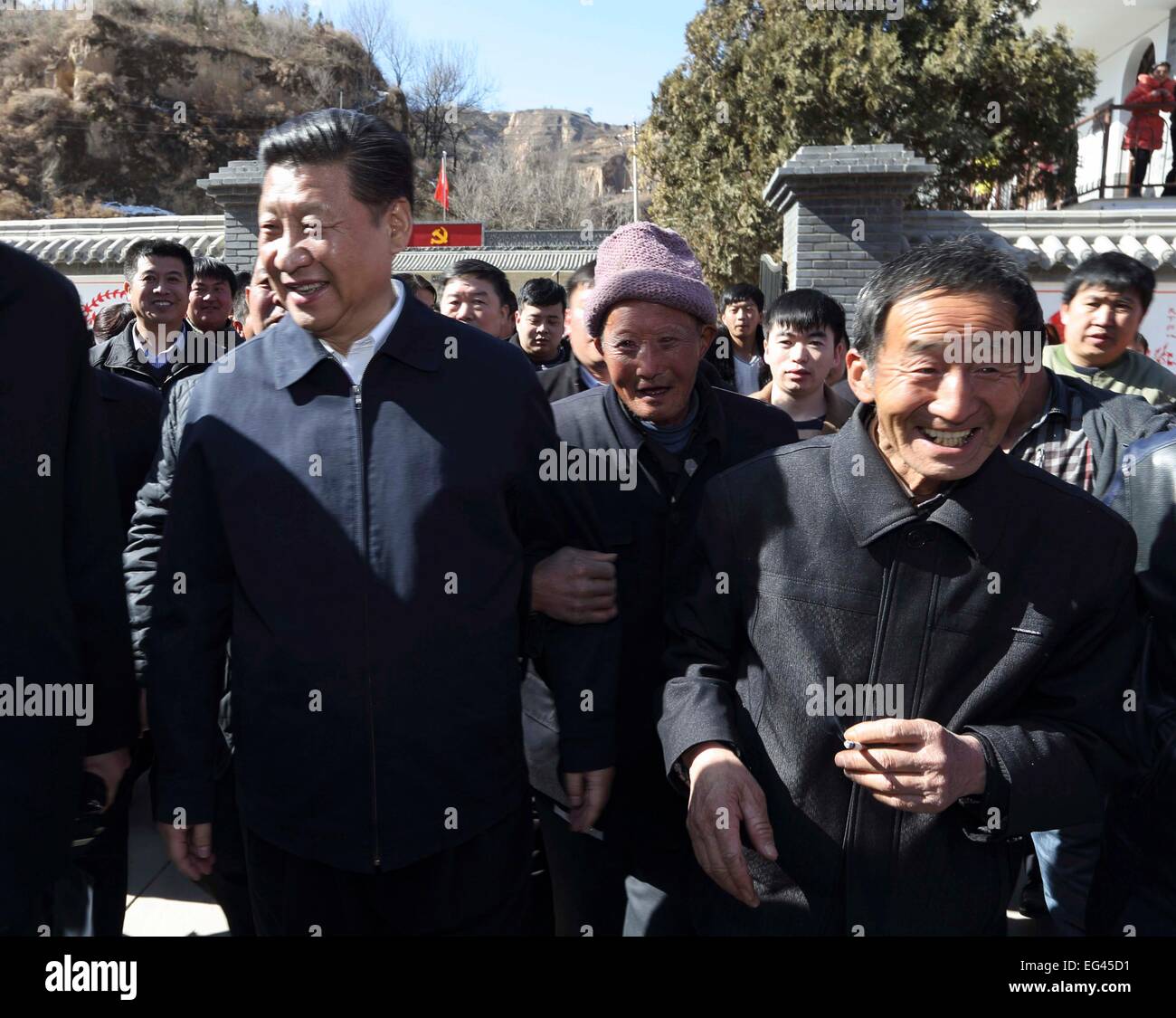 Xi'an, China's Shaanxi Province. 13th Feb, 2015. Chinese President and General Secretary of the Communist Party of China Central Committee Xi Jinping (L front), also chairman of the Central Military Commission, walks with locals while visiting Liangjiahe Village, Wen'anyi Township of Yanchuan County, Yan'an, northwest China's Shaanxi Province, Feb. 13, 2015. Xi made a tour in Shaanxi on Feb. 13 - 16, and extended festival greetings to locals and people across the nation ahead of the Spring Festival, which falls on Feb. 19. © Lan Hongguang/Xinhua/Alamy Live News Stock Photo