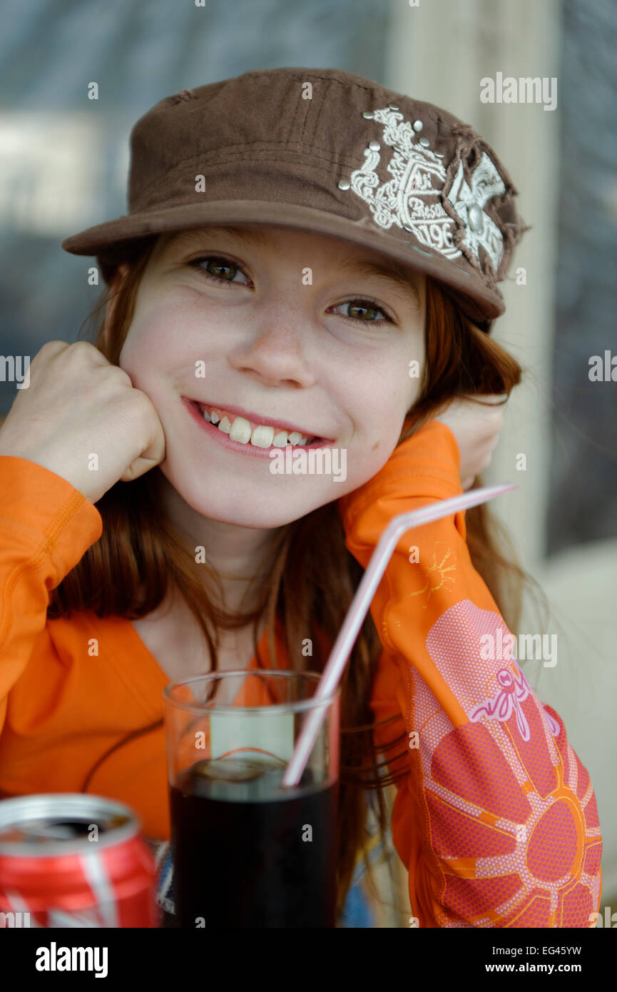 Girl with cap, with drink and straw, Corsica, France Stock Photo Alamy