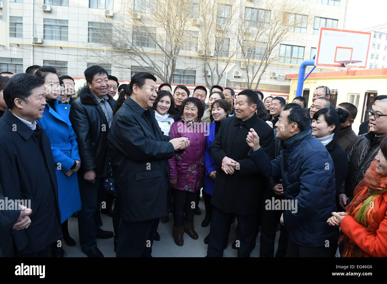 Xi'an, China's Shaanxi Province. 14th Feb, 2015. Chinese President and General Secretary of the Communist Party of China Central Committee Xi Jinping, also chairman of the Central Military Commission, chats with local residents after visiting the faculty of a primary school in Yan'an, northwest China's Shaanxi Province, Feb. 14, 2015. Xi made a tour in Shaanxi on Feb. 13 - 16, and extended festival greetings to locals and people across the nation ahead of the Spring Festival, which falls on Feb. 19. © Li Xueren/Xinhua/Alamy Live News Stock Photo