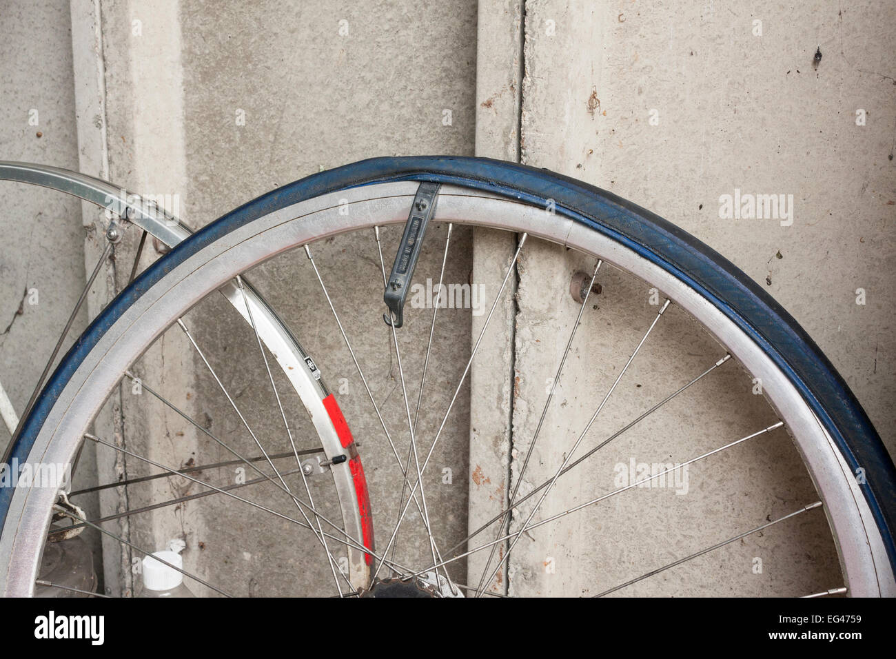 Tyre lever in place on bicycle wheel to remove tyre to aid in puncture