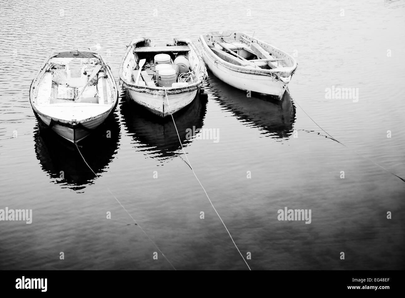 Black white image three punts Mevagissey Cornwall England January. Stock Photo