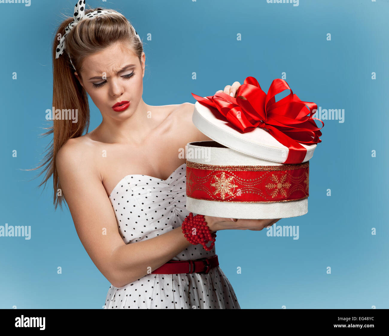 Suspicious girl opening gift box Stock Photo