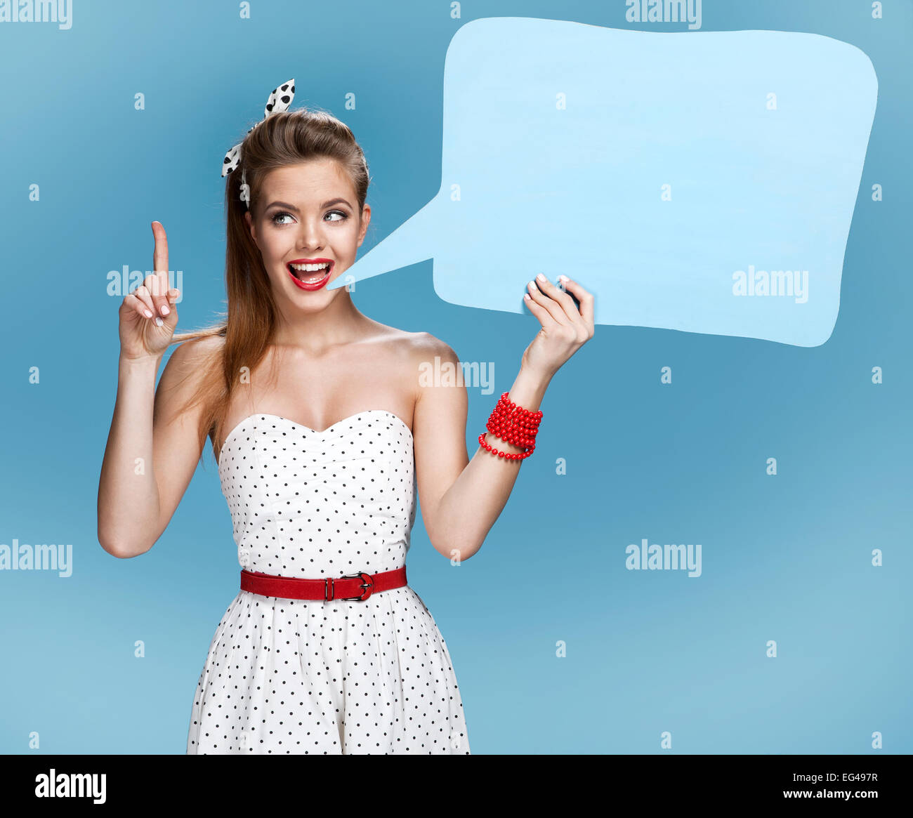 Young talkative woman showing sign speech bubble banner looking happy excited Stock Photo