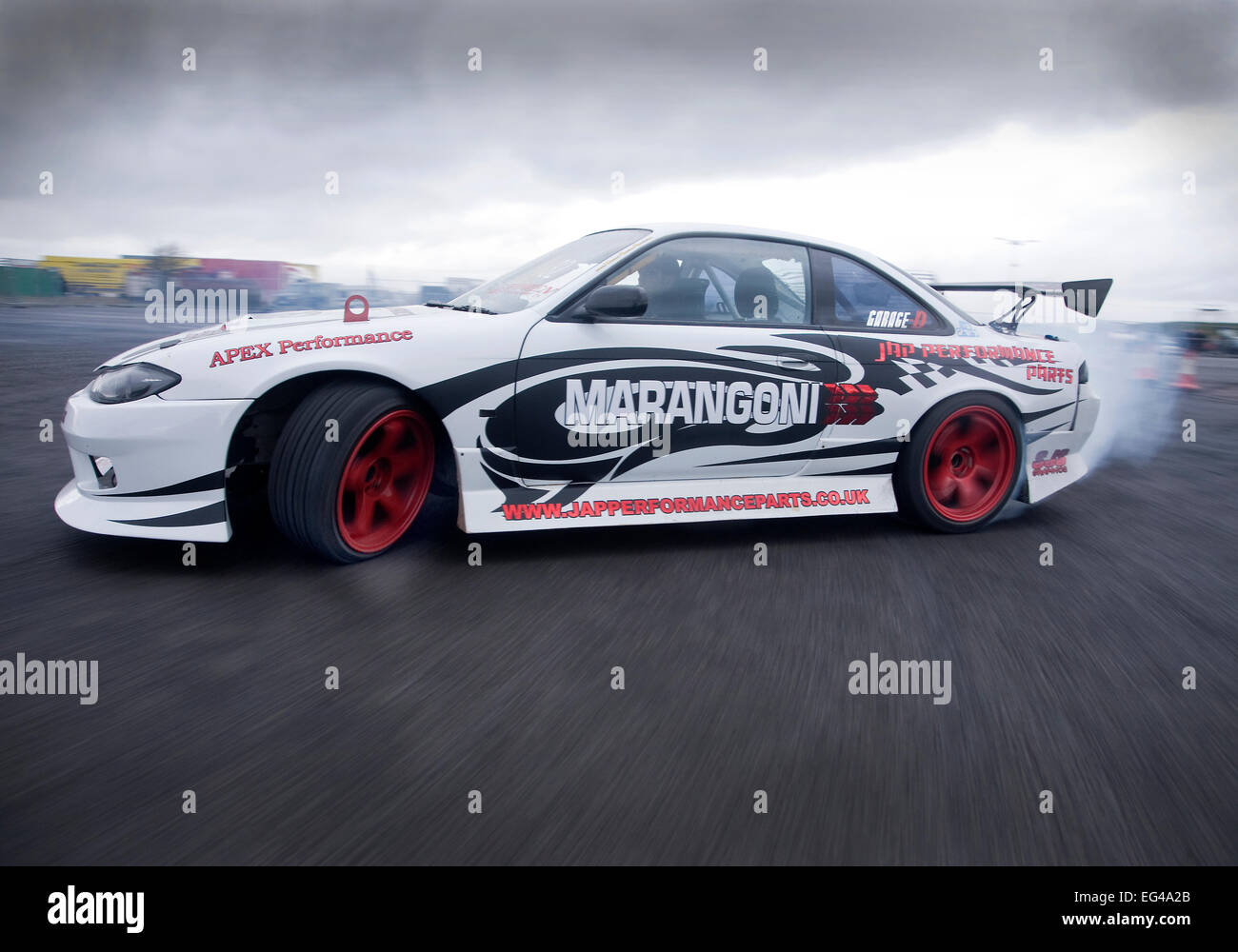 Nissan S14 drift car traveling sideways on a long drift (skid) Stock Photo