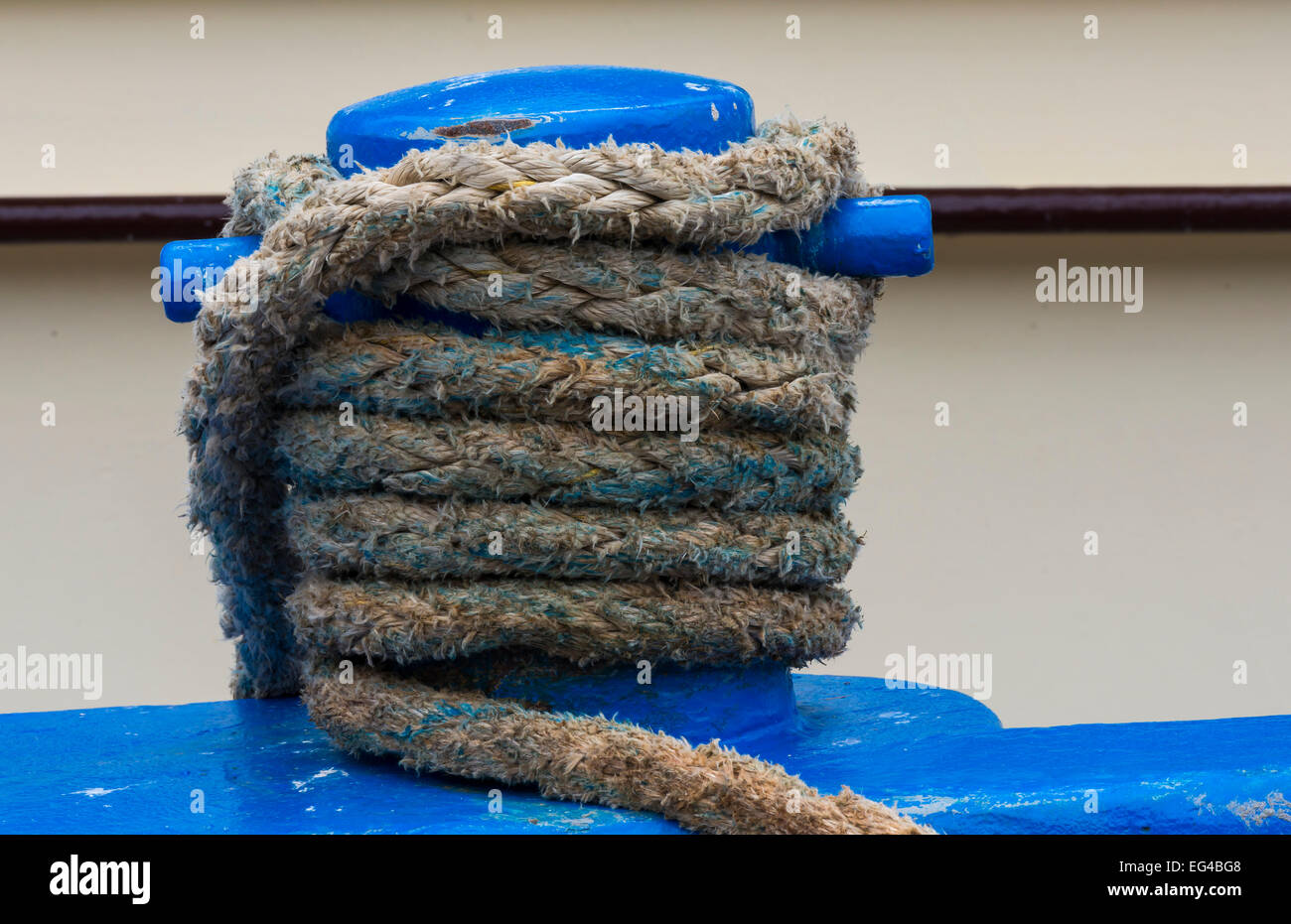 Blue Bollard with rope. Stock Photo