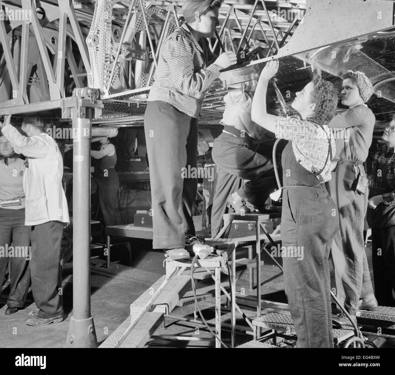 Production. B-17 heavy bomber. Women workers at the Boeing plant in Seattle helps to complete sections which will be added to the fuselage sections of new B-17F (Flying Fortress) bombers, 1942 Stock Photo