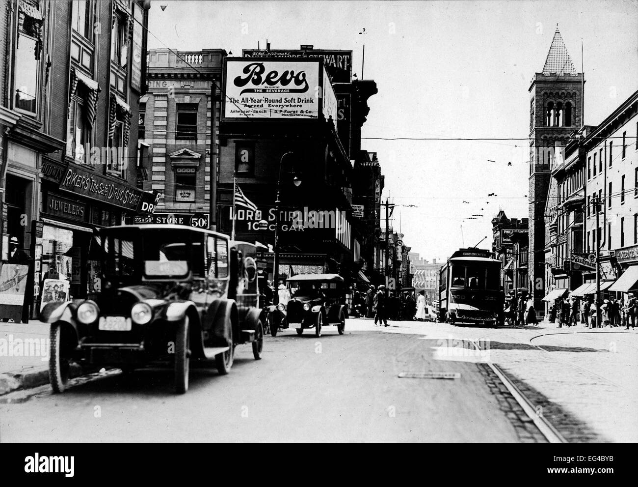 Street scene at State & Broad Streets. Visible are period automobiles, streetcar, commercial building, billboard advertising 'Bevo' (near-beer), Trenton, NJ, circa 1920 Stock Photo