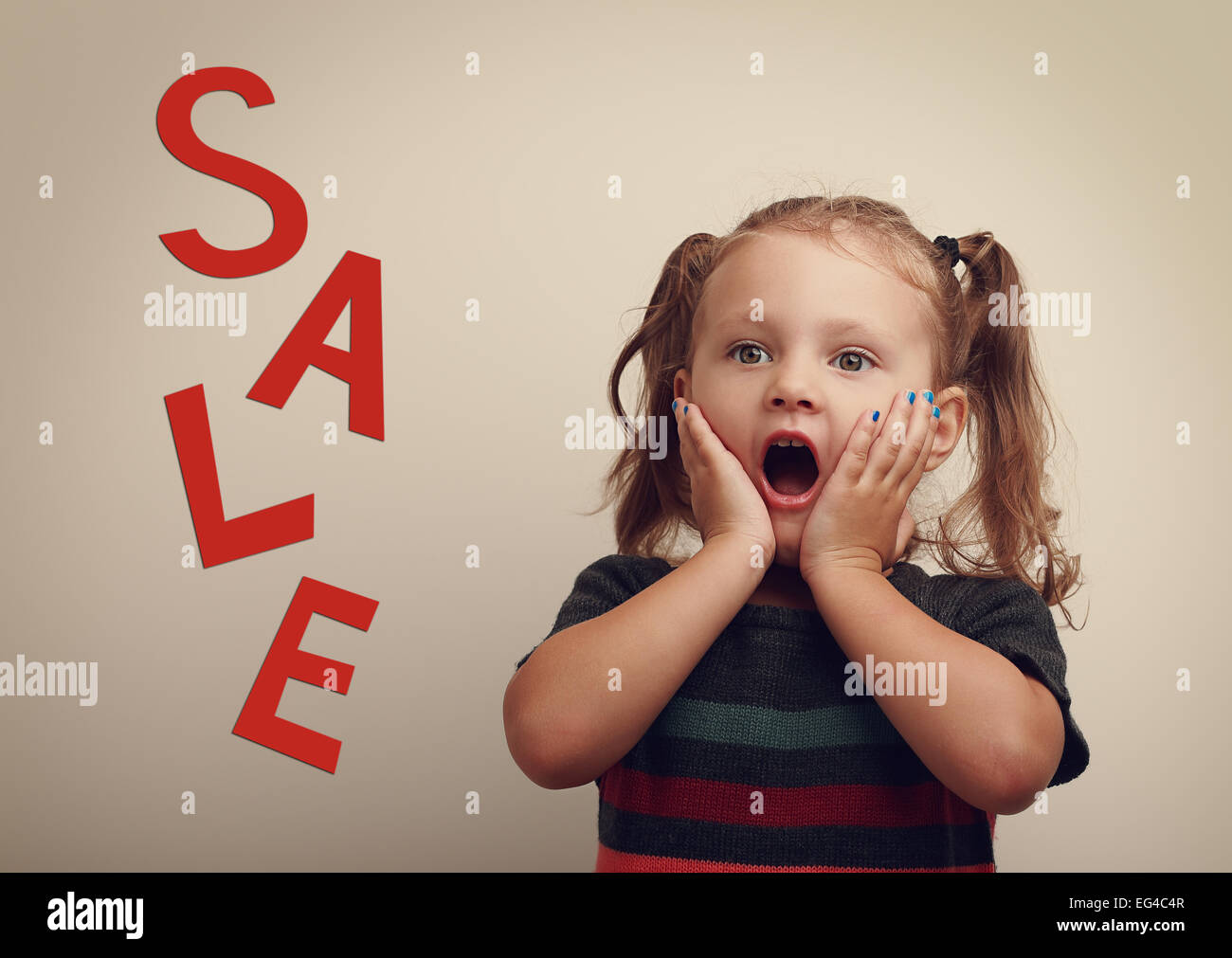 Surprising cute kid girl looking on sale text advertising with open mouth. Vintage portrait Stock Photo