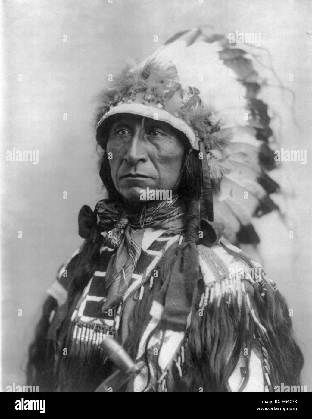 Lone Bear - Sioux Indian, bust portrait, wearing feathered head dress, facing left, circa 1899 Stock Photo