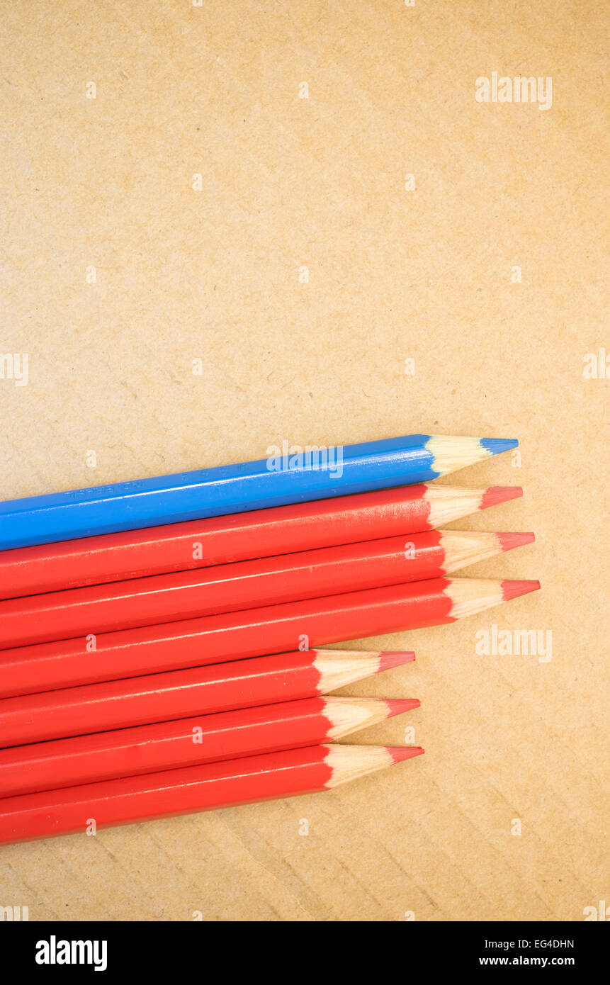 red blue colored crayons close up on a blurred light paperboard ...