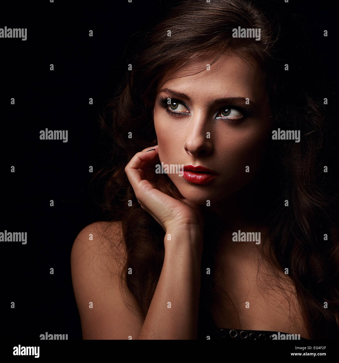 Dramatic woman face looking with fear. Closeup portrait on black Stock ...