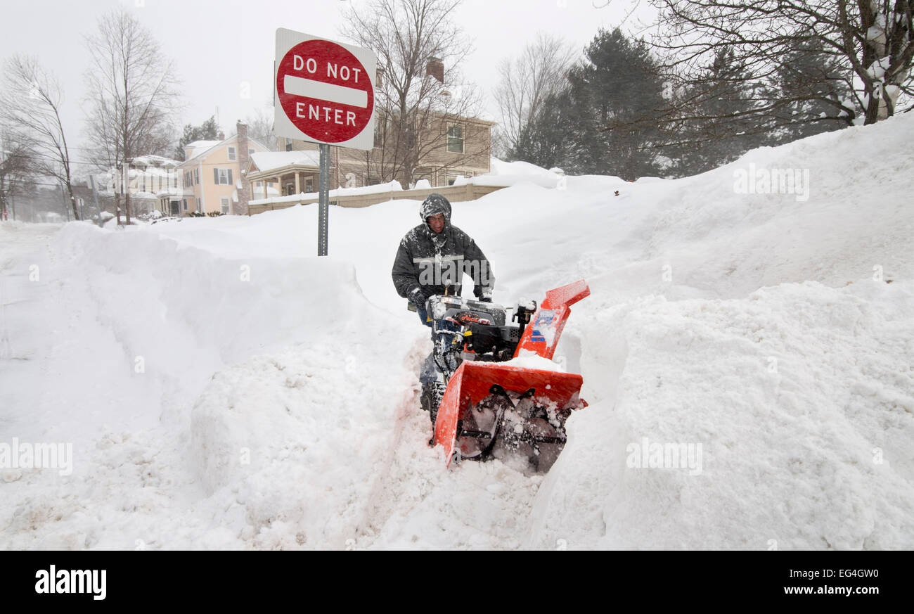 Lexington, MA, 15 Feb, 2015. Resident blowing snow from his Forest