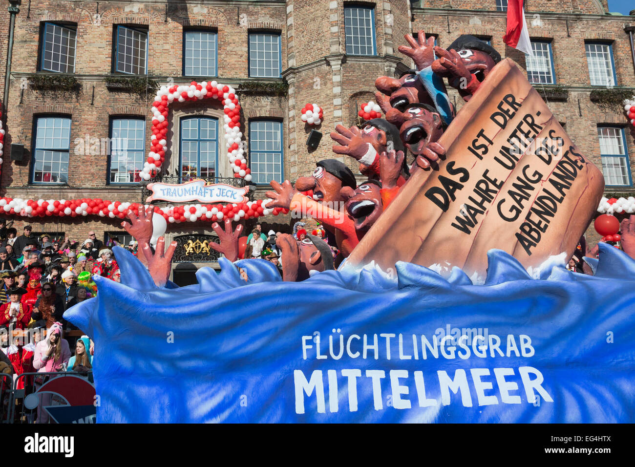 Düsseldorf, Germany. 16 February 2015. A float depicts refugees in a sinking ship on the Mediterranean.  The traditional Shrove Monday (Rosenmontag) carnival parade takes place in Düsseldorf, Germany. 1.2 million revellers lined the route. The Monday parades went ahead despite increased terror warnings which led to the parade in Brunswick (Braunschweig) being cancelled shortly before it was due to take place. Photo. carnivalpix/Alamy Live News Stock Photo