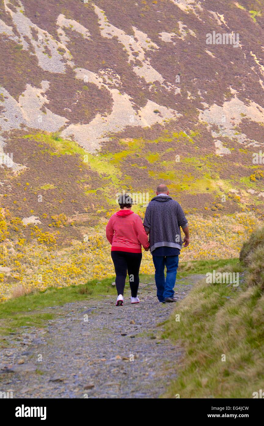 Couple decending Bowscale Fell. Mungrisdale, Cumbria, England, UK. Stock Photo