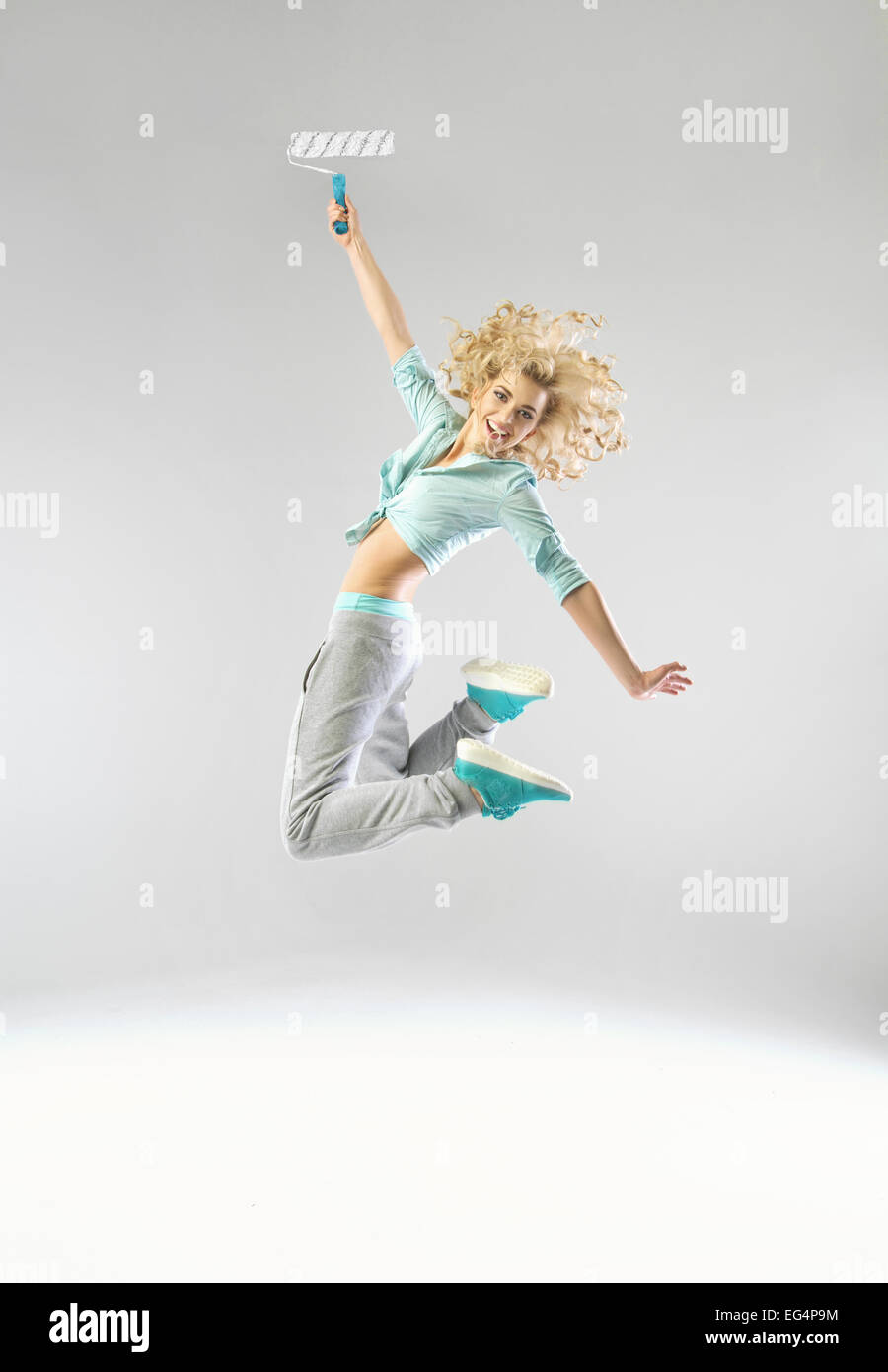 Jumping lady with a paint roller Stock Photo Alamy