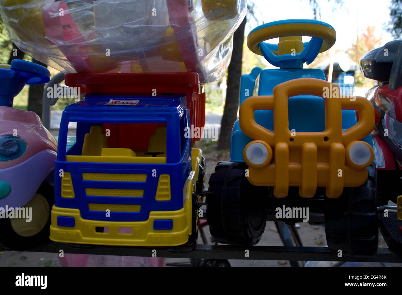 Children's toys large trucks are on racks in front of shops for toys
