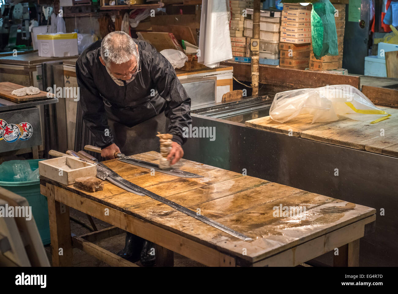 TOKYO, JAPAN - November, 22, 2014: Old japanese man with traditional knives at Tsukiji, the biggest fish and seafood market in t Stock Photo