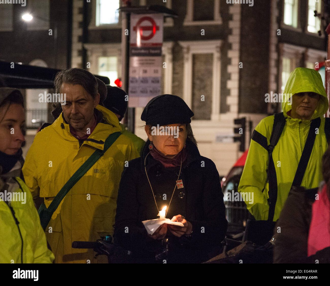 London, UK. 16th February 2015. A woman holds a candle during speeches as cyclists and their supporters congregate for a vigil and die-in held in the memory of Federica Baldassa, who died when she was knocked down by a lorry as she cycled through Vernon Place in Holborn on the 6th February this year. The protest and vigil was called by cycling campaigning group 'Stop Killing Cyclists'. Credit:  Patricia Phillips/Alamy Live News Stock Photo