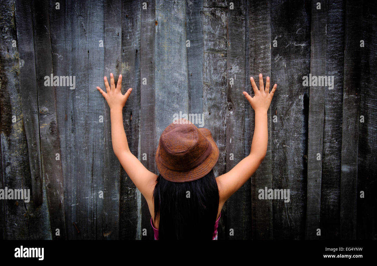 girl, back, hands, wood, game, play, hat, victim, colors, cold, loneliness, childhood, war, family Stock Photo