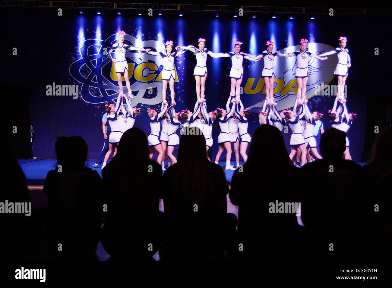 Cheer Leaders competition for High School State Championship with fans silhouette Stock Photo