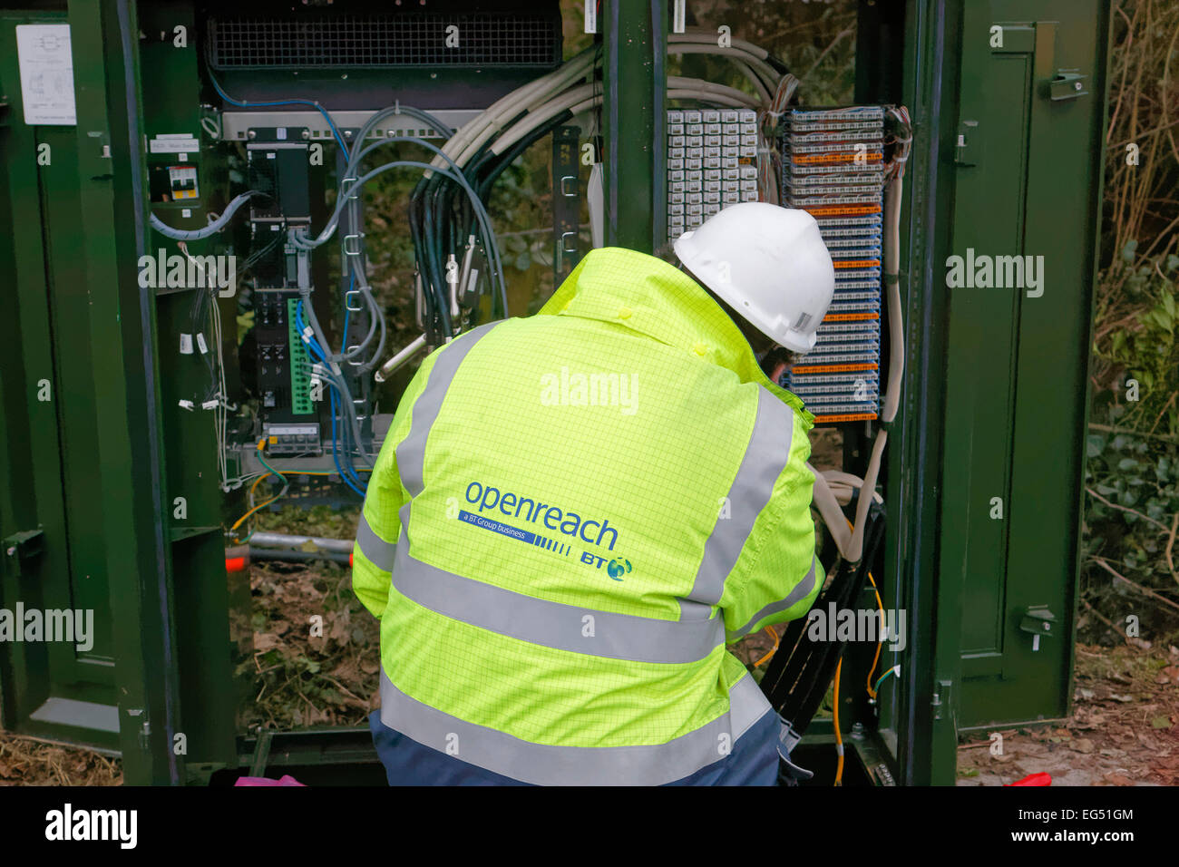 BT Openreach engineer working on a broadband internet fibre cabinet in the street Stock Photo