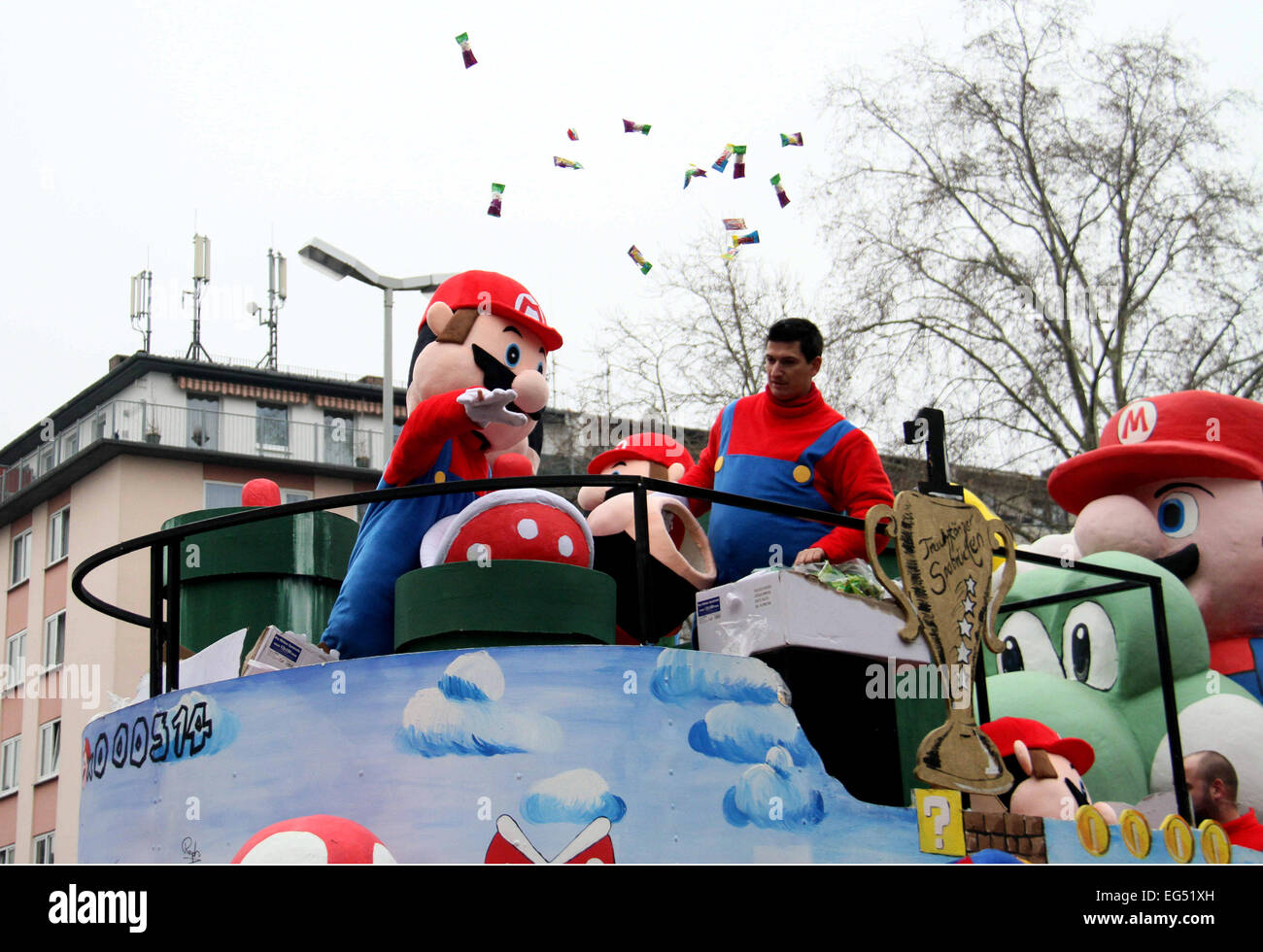 Mainz, Germany. 16th Feb, 2015. An actor in the costume of Super Mario  throws candies during the traditional Rose Monday carnival parade in the  western German city of Mainz, Feb. 16, 2015.