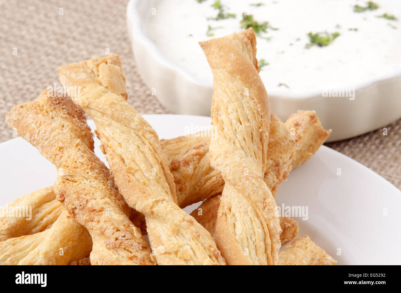 baked breadsticks with dip in a small bowl Stock Photo Alamy