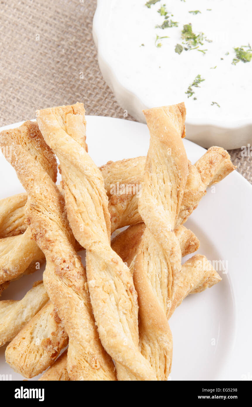 baked breadsticks with dip in a small bowl Stock Photo Alamy