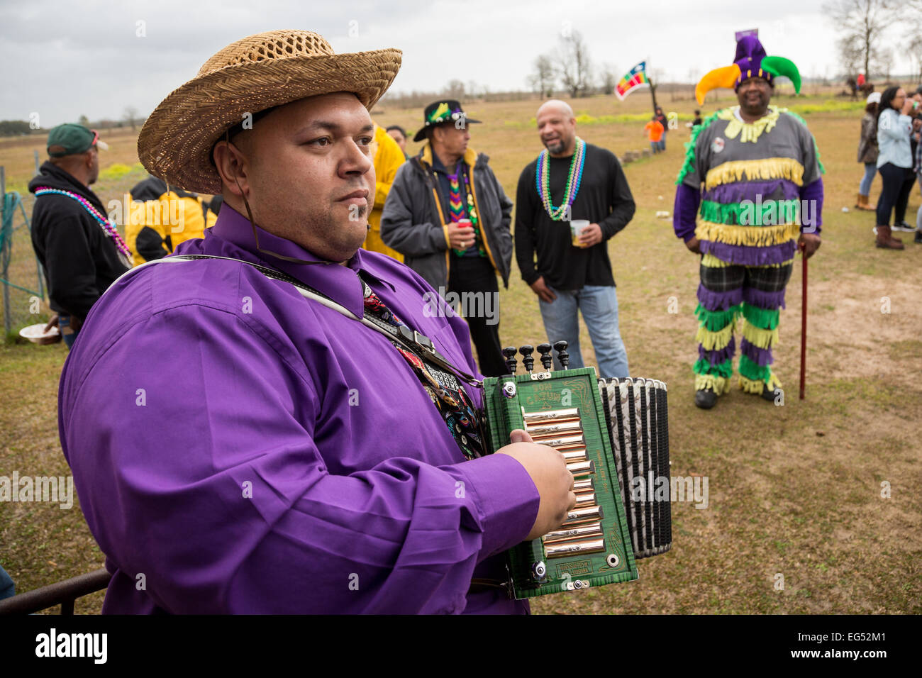 A zydeco musician plays the accordion during a stop at the Creole Courir de Mardi Gras chicken run February 16, 2015 in Soileau, Louisiana. The traditional rural Mardi Gras event evolved from the exclusion by white communities of black and indian residents from the larger local celebrations. Stock Photo