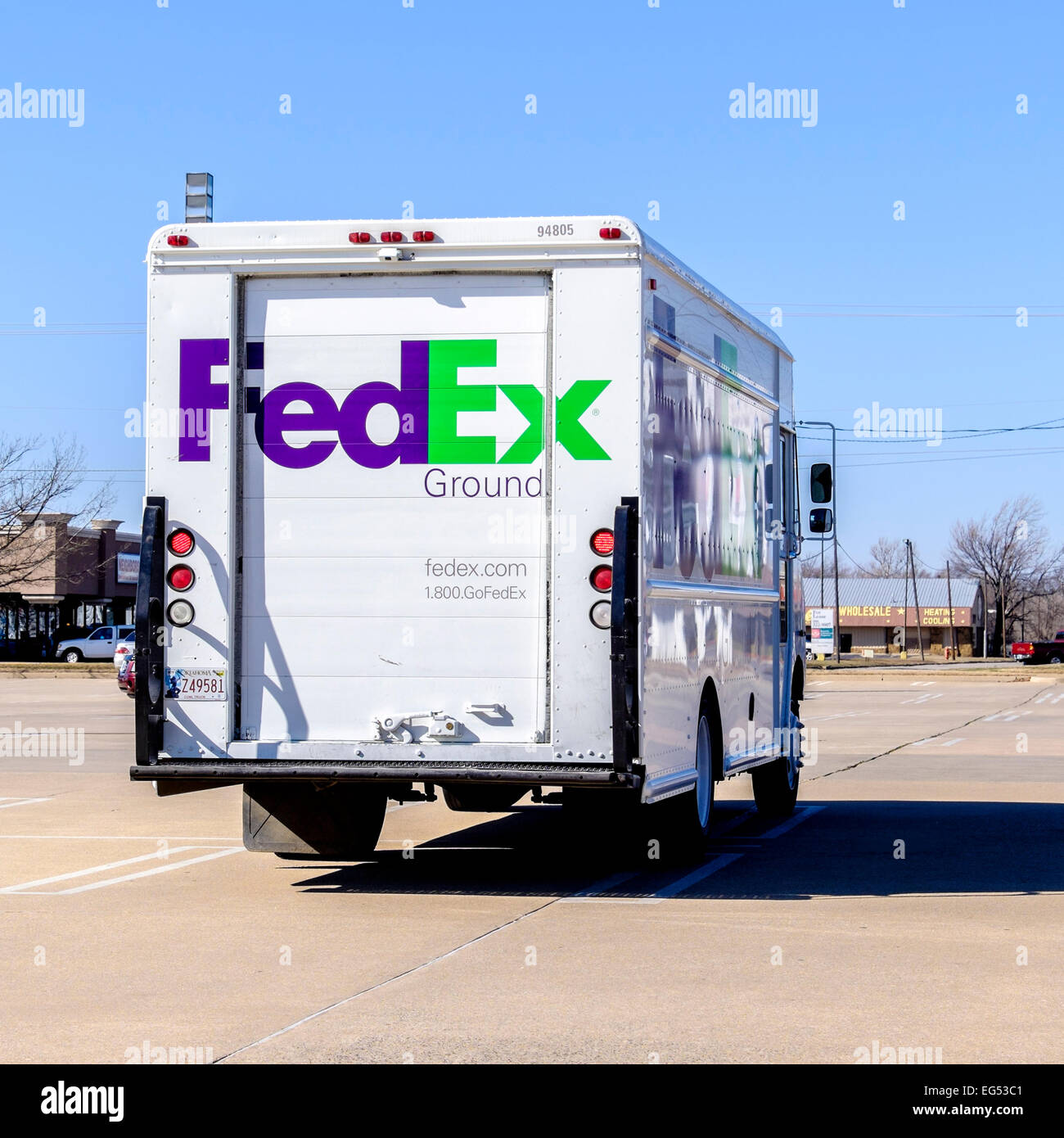 The rear of a FedEx delivery truck parked in a parking lot. Stock Photo