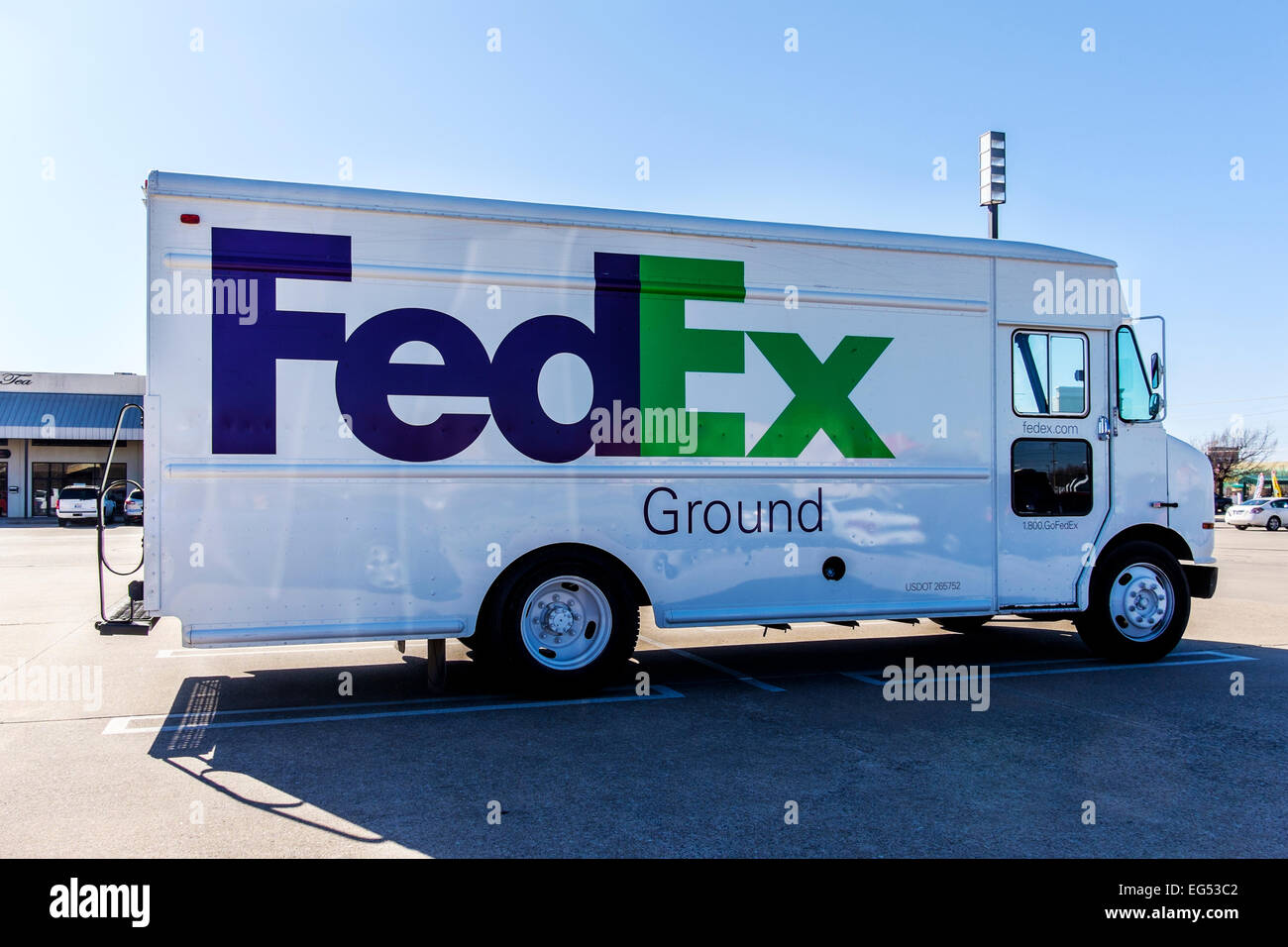 A FedEx delivery truck parked in a parking lot. Stock Photo