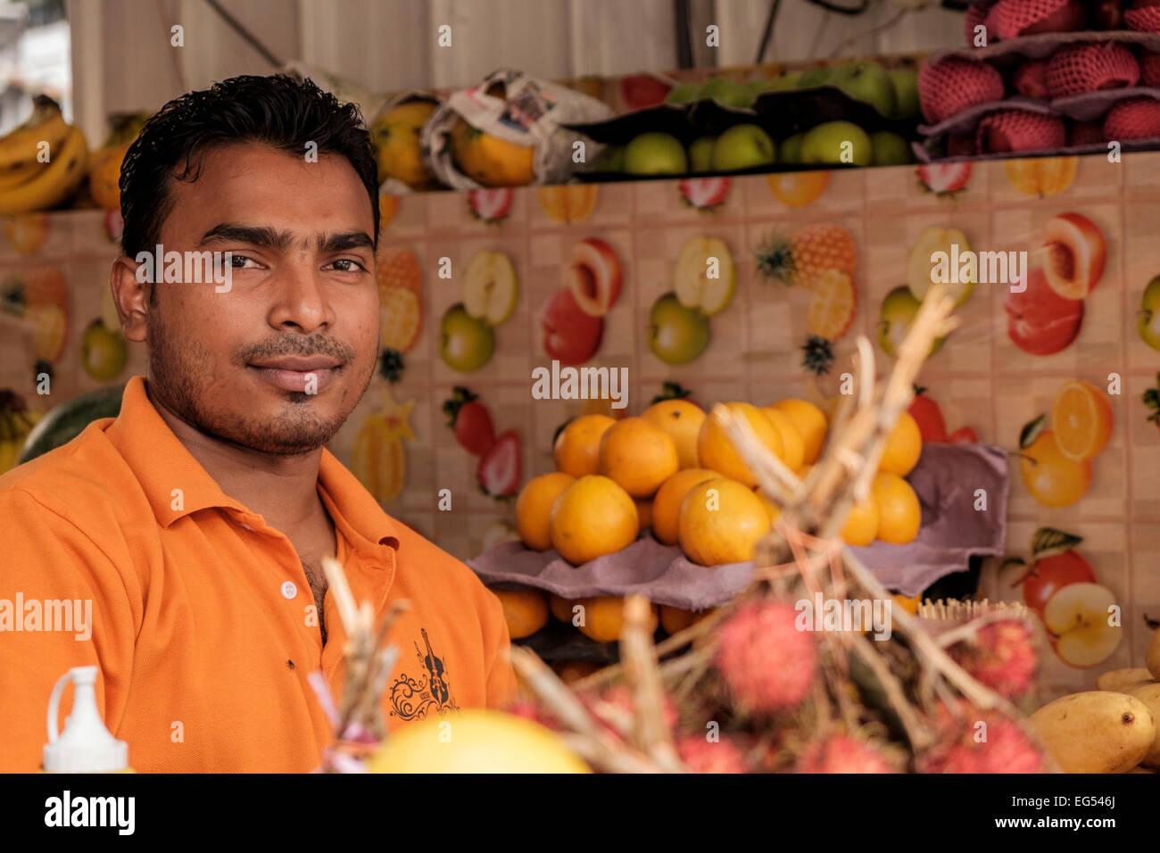 Stall holder at a fruit and veg stand in the street in Kuala Lumpur, Malaysia. Stock Photo