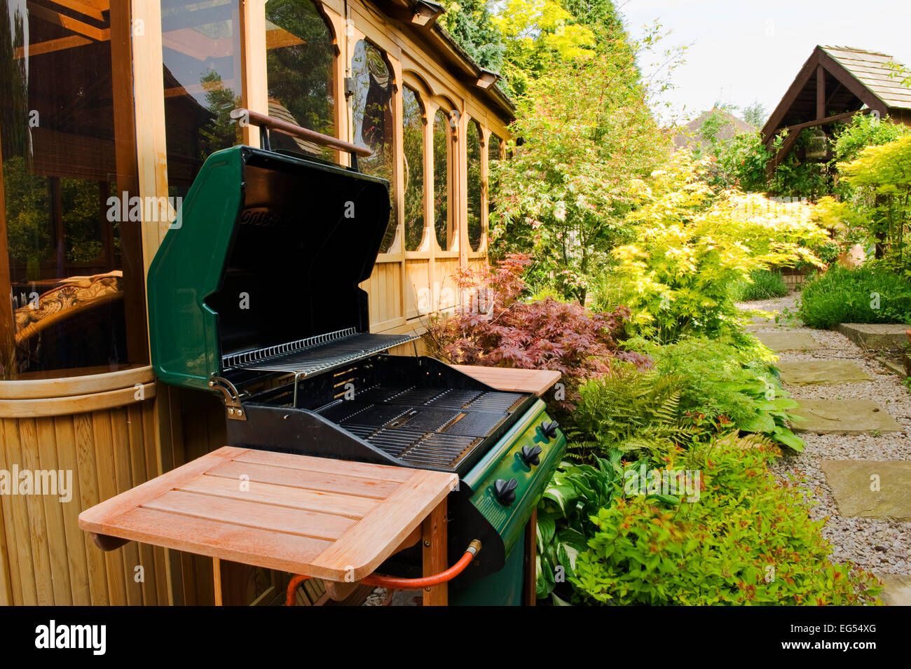 gas barbeque outside a cedar gazeebo Stock Photo