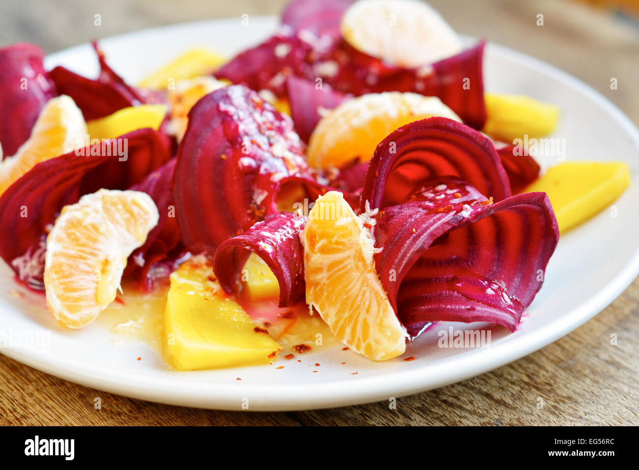 Raw Beet Salad with Tangerines and Mangoes with Coconut Mango Dressing Stock Photo