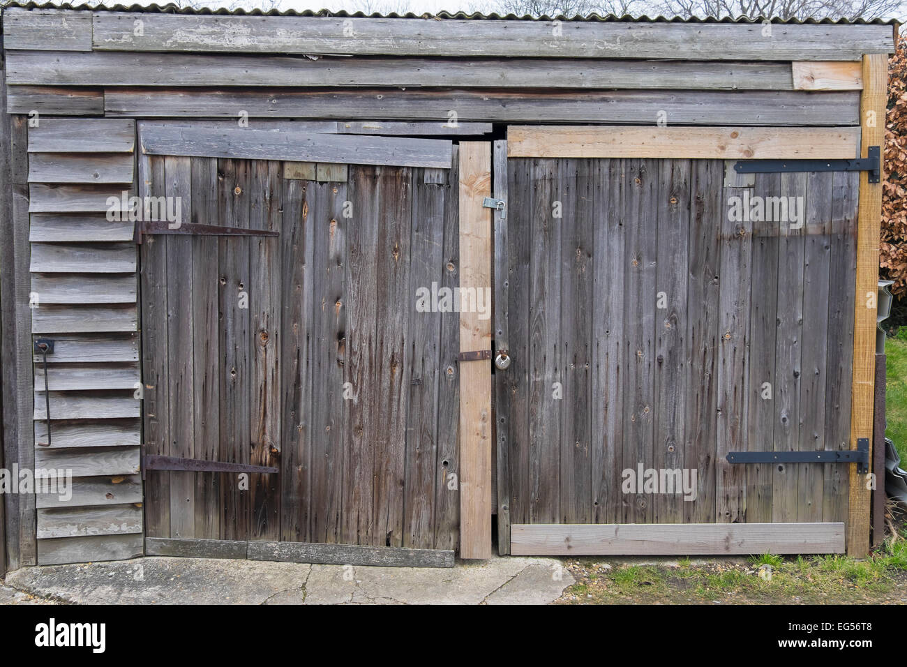 Old wood garage doors needing refurbishment Stock Photo