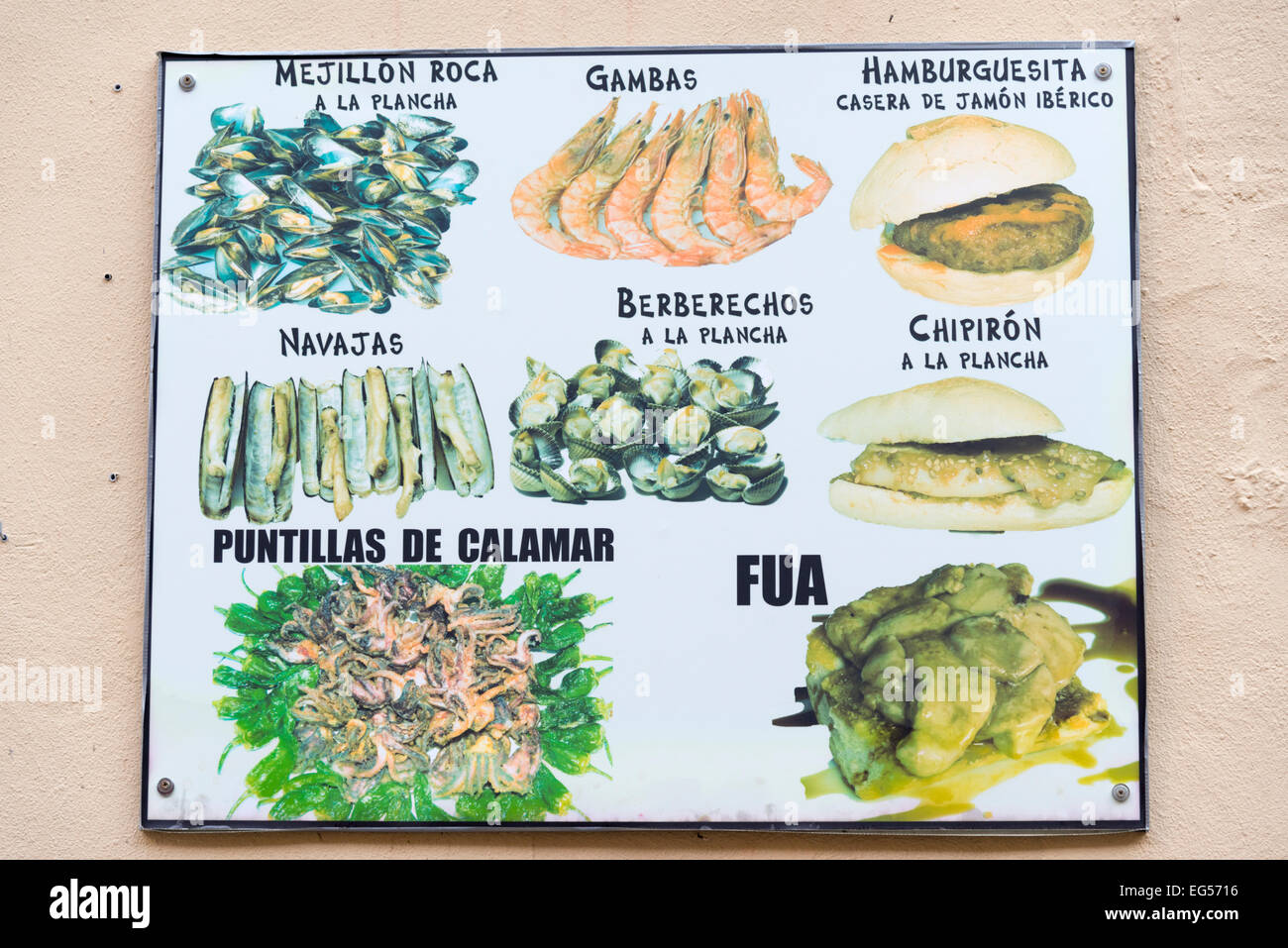 A menu at a spanish restaurant or cafe in Spain with photographs of the food available Stock Photo