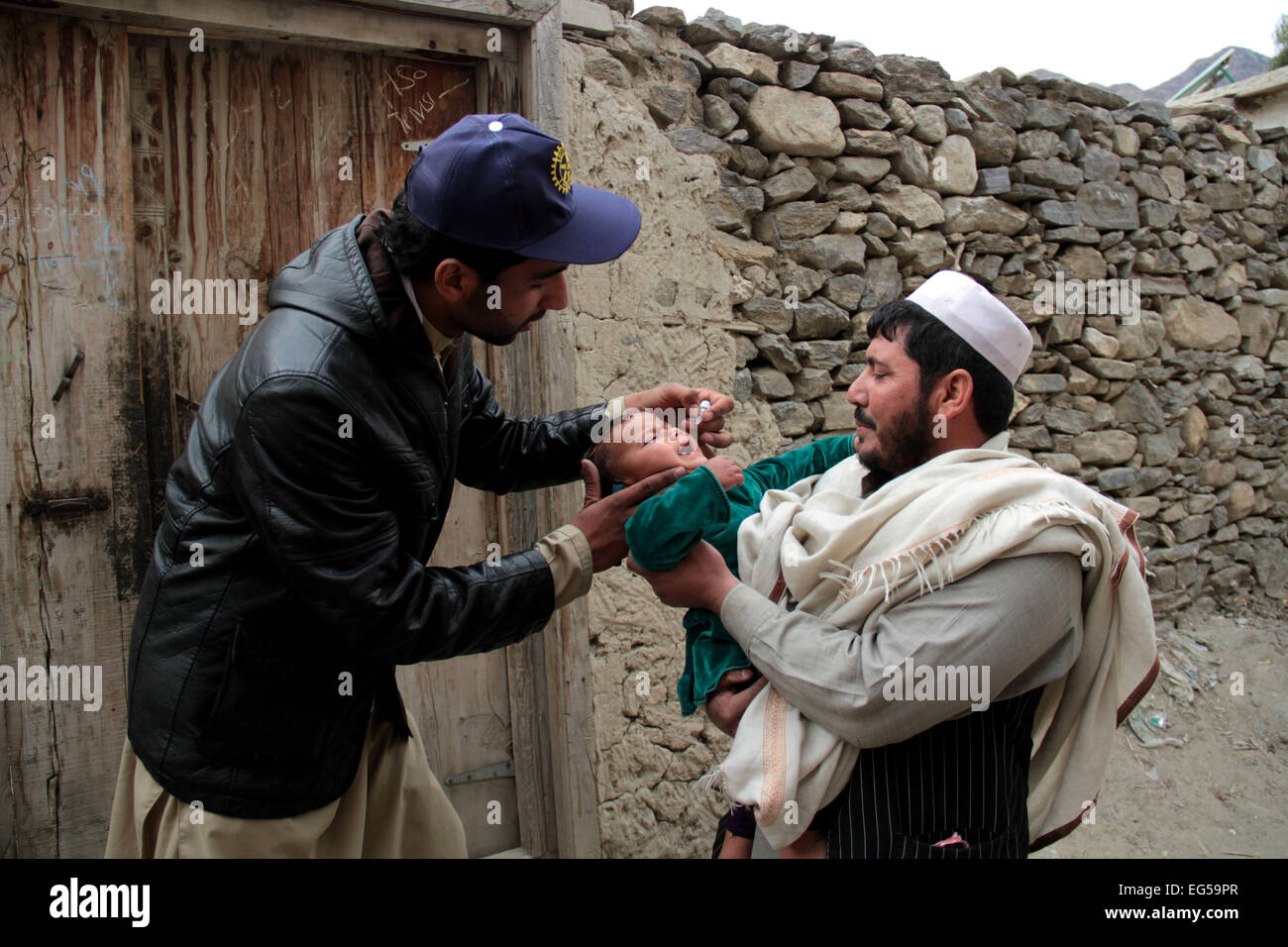 Kunar. 17th Feb, 2015. An Afghan health worker gives a polio vaccine to