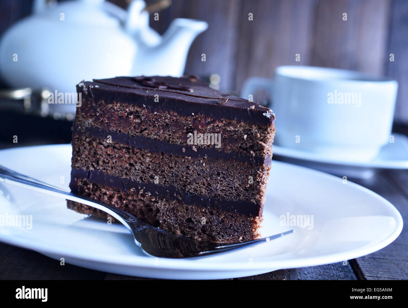chocolate cake on white plate and on a table Stock Photo - Alamy
