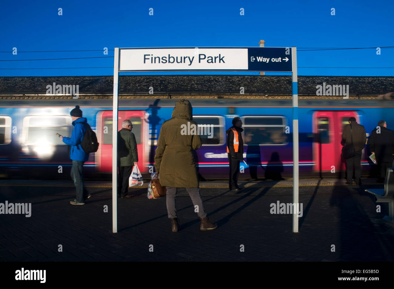 Commuters wait for their train at Finsbury Park, London Stock Photo Alamy