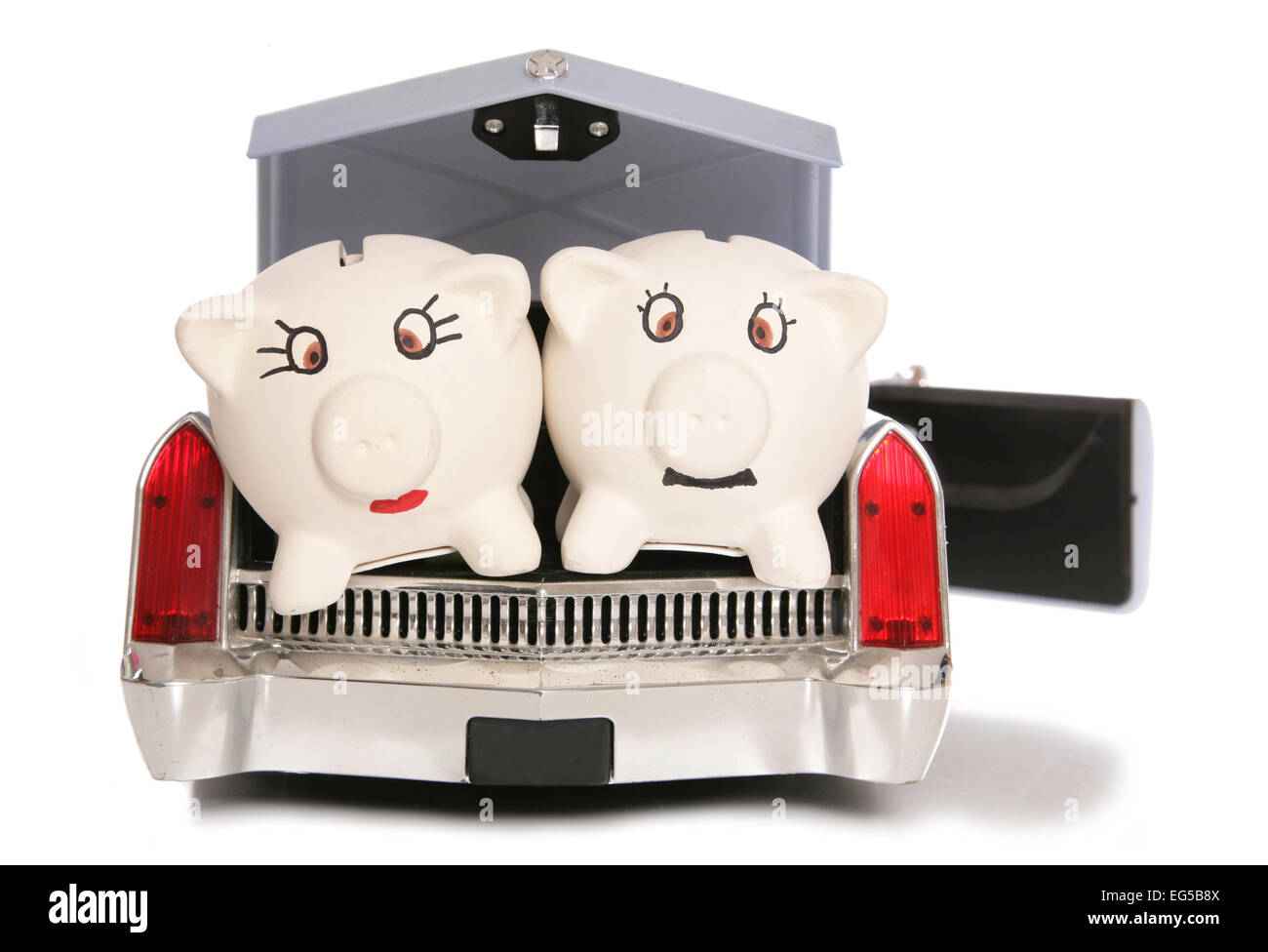 mr and mrs piggy bank in back of american car cutout Stock Photo