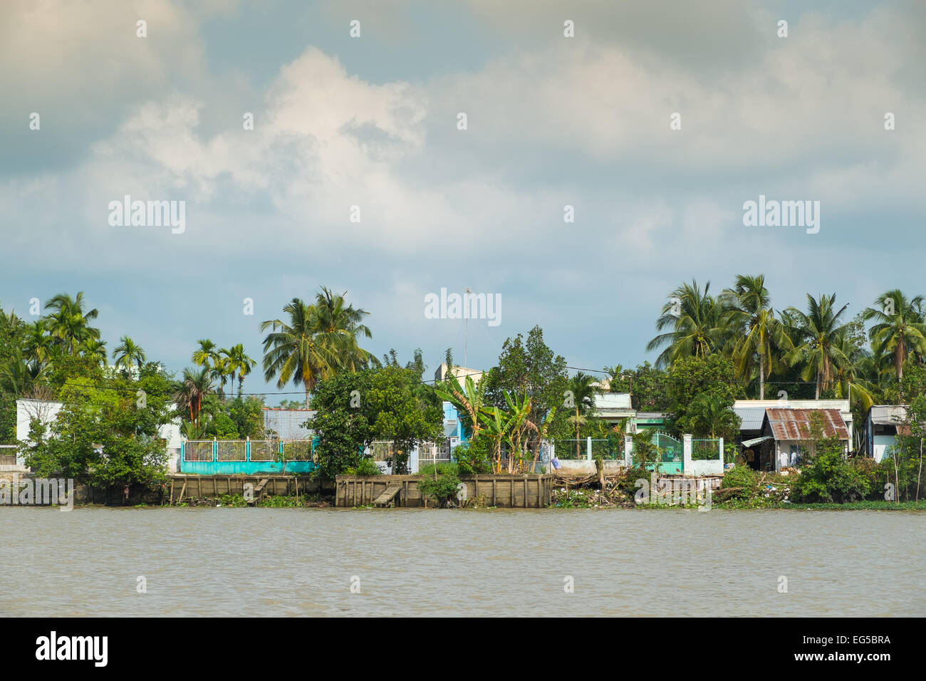 Run down houses on the bank of Mekong river on January 26, 2014 in Can Tho, Vietnam. Stock Photo